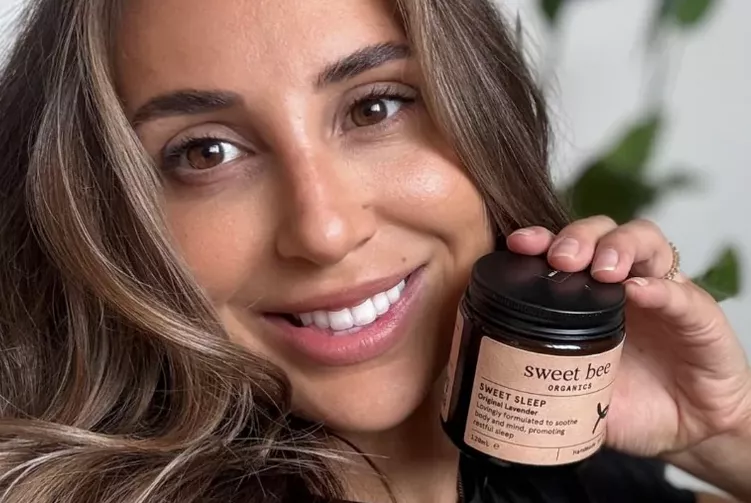Review Photo 3 – customer Shelby K. smiling and holding a Sweet Sleep jar