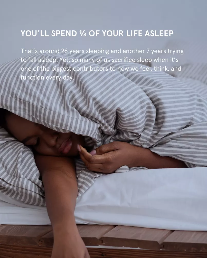 Sleep Fact – Brain Detox – woman sleeping under a striped duvet, text says you spend a third of your life asleep