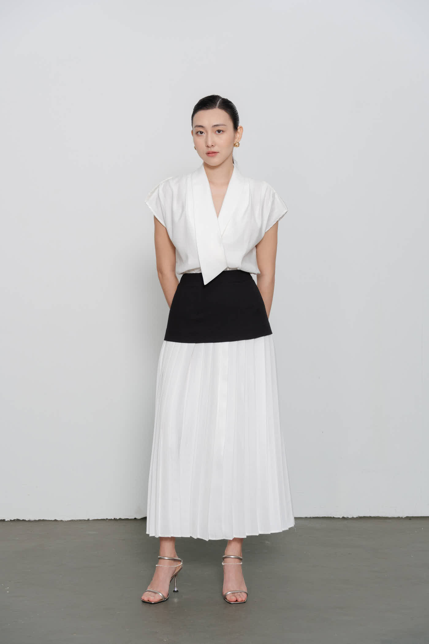 Pressed-pleat black-waistband skirt