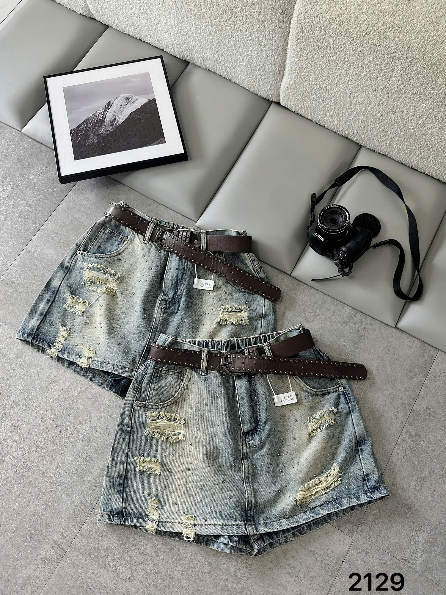 Hai quần giả váy jean T-QVJ2129 xanh wash nhạt nhìn rõ mặt trước, rách tua và đá nhỏ