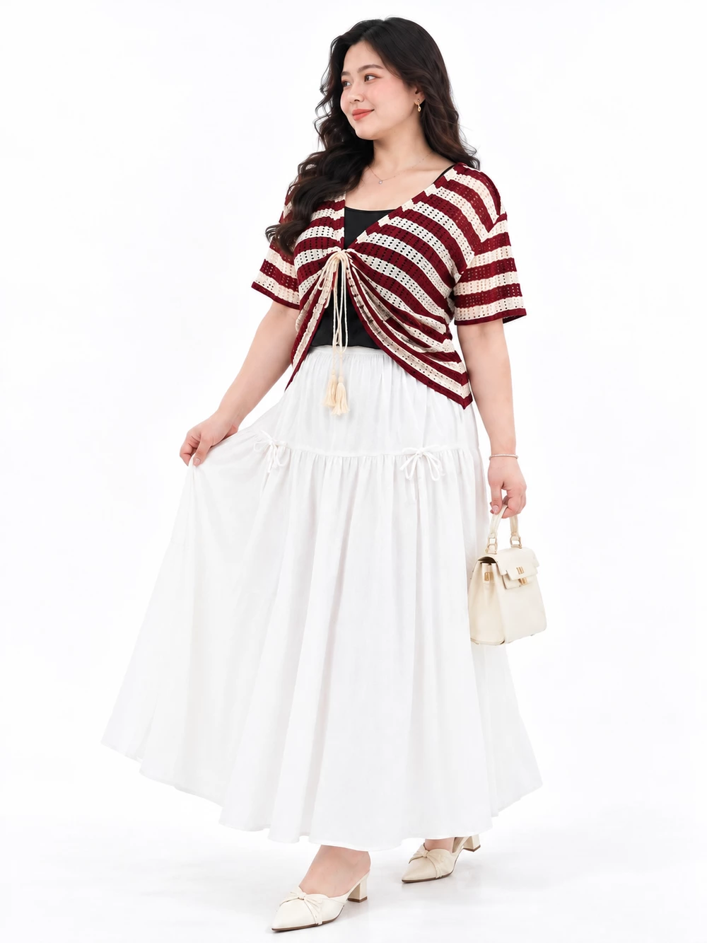Side view of the model wearing the V-AK132 tie-front top with roomy sleeves and a white skirt