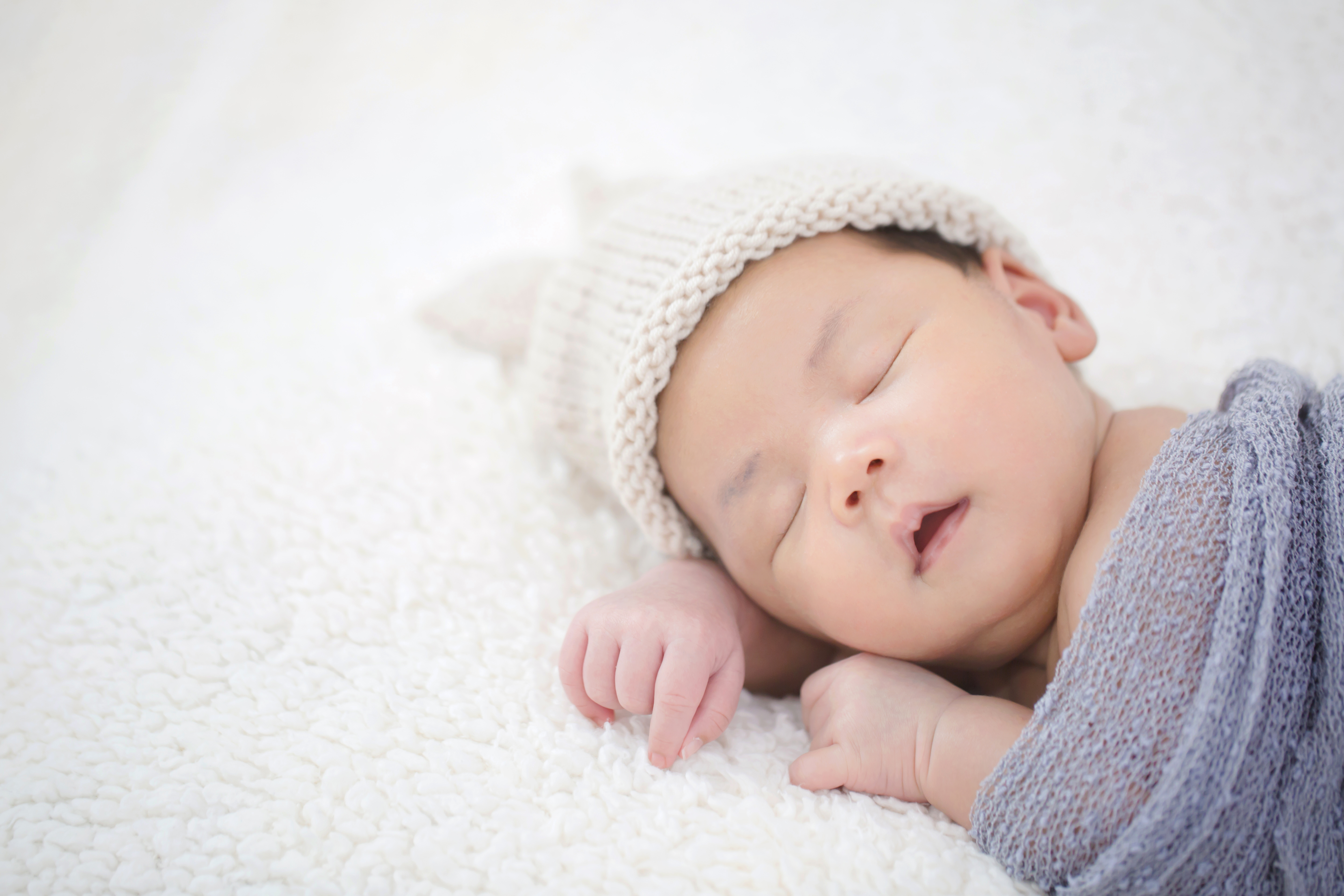 lovely-newborn-asian-baby-sleeping-furry-cloth