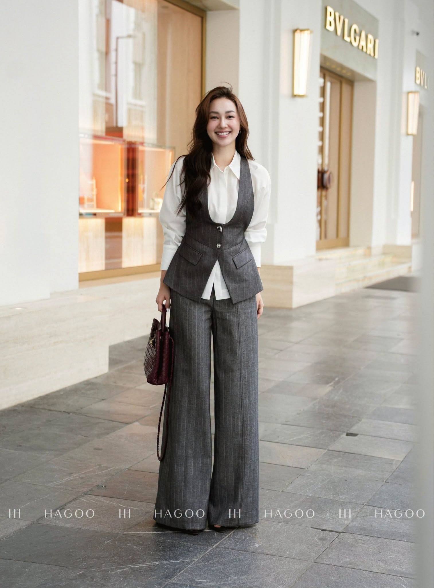 Asymmetrical vest with decorative buttons