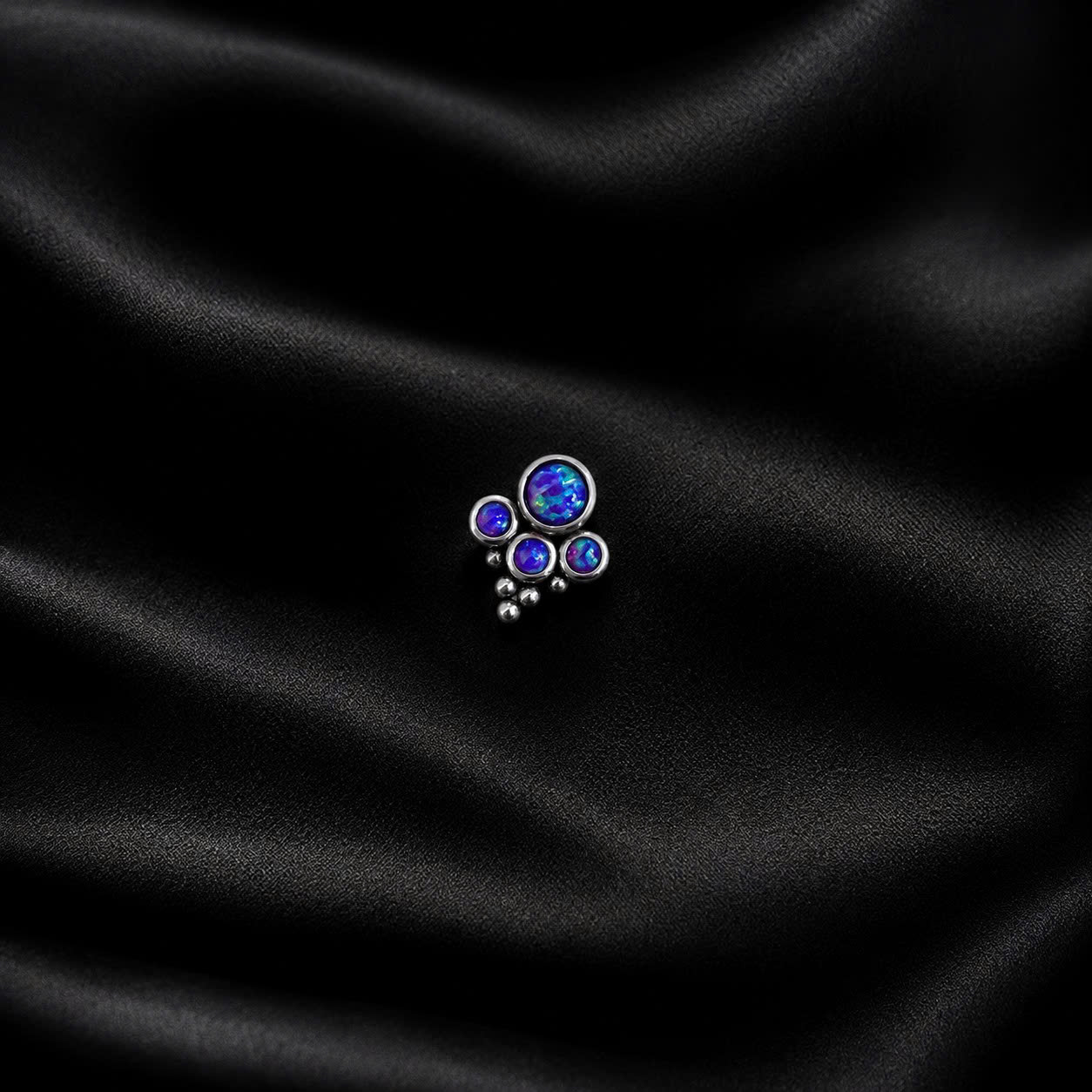 Khuyên kiểu đá opal tím xanh bo viền