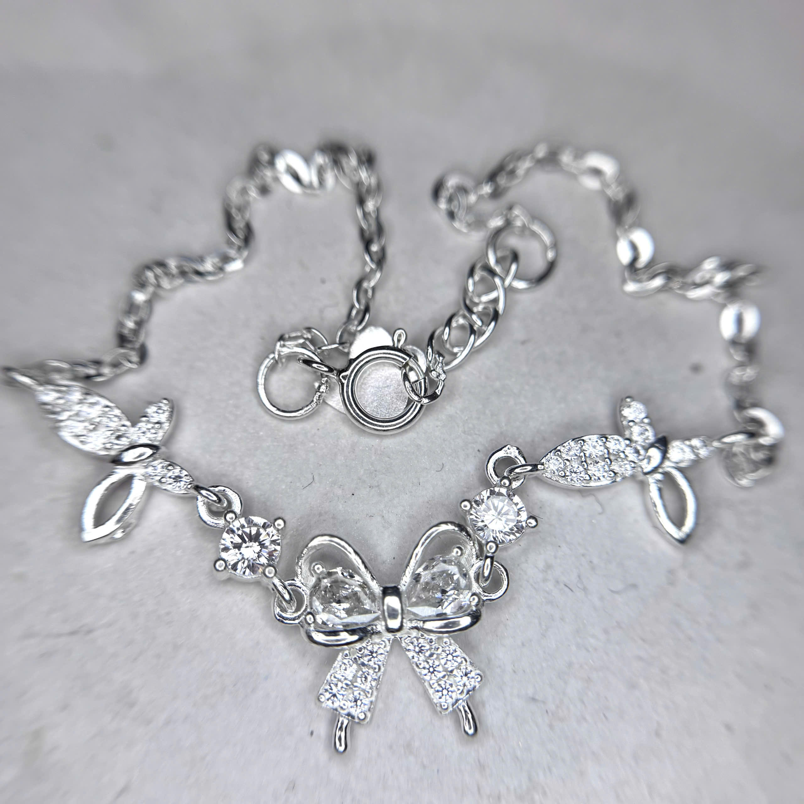 Vòng tay bạc xi bạch kim nơ trắng