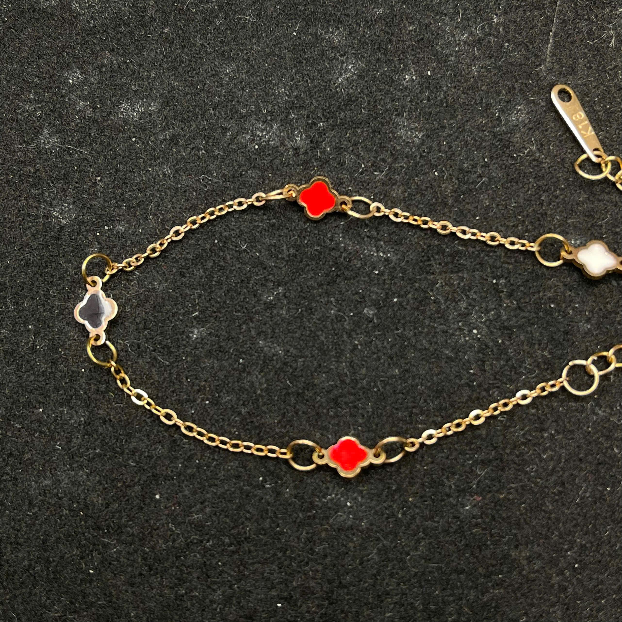 vòng tay titan màu vàng charm hoa bốn cánh đỏ trắng đen._thumbnail_1