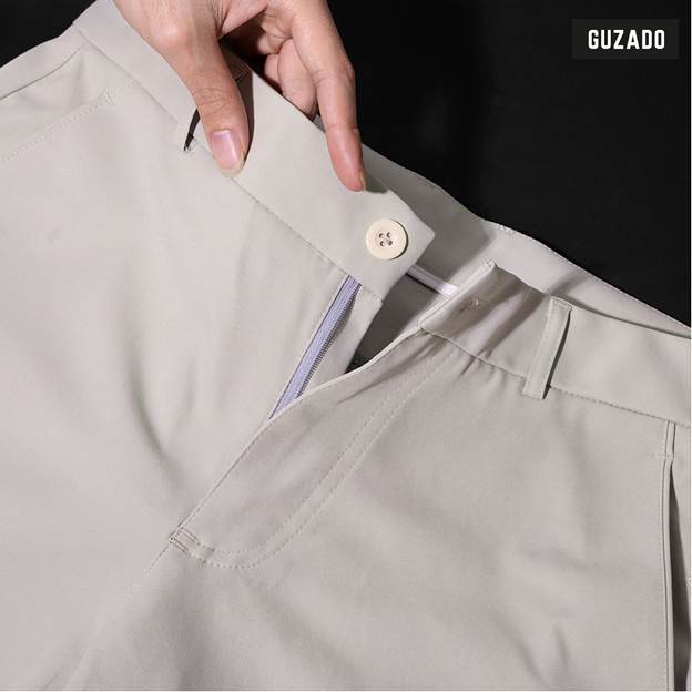 A person's hand holding a button on a pair of pants

AI-generated content may be incorrect.