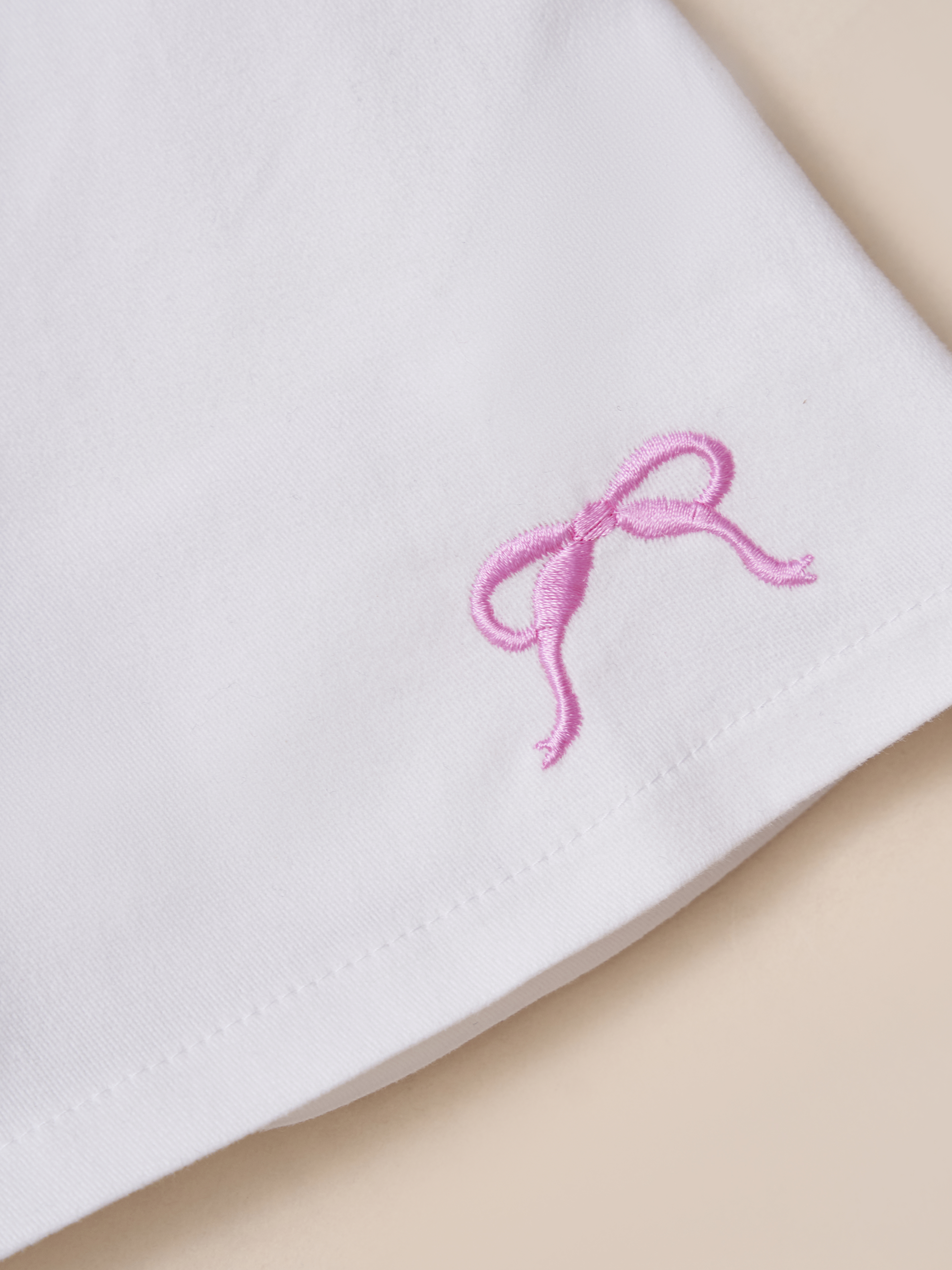 Chân váy kaki thêu nơ