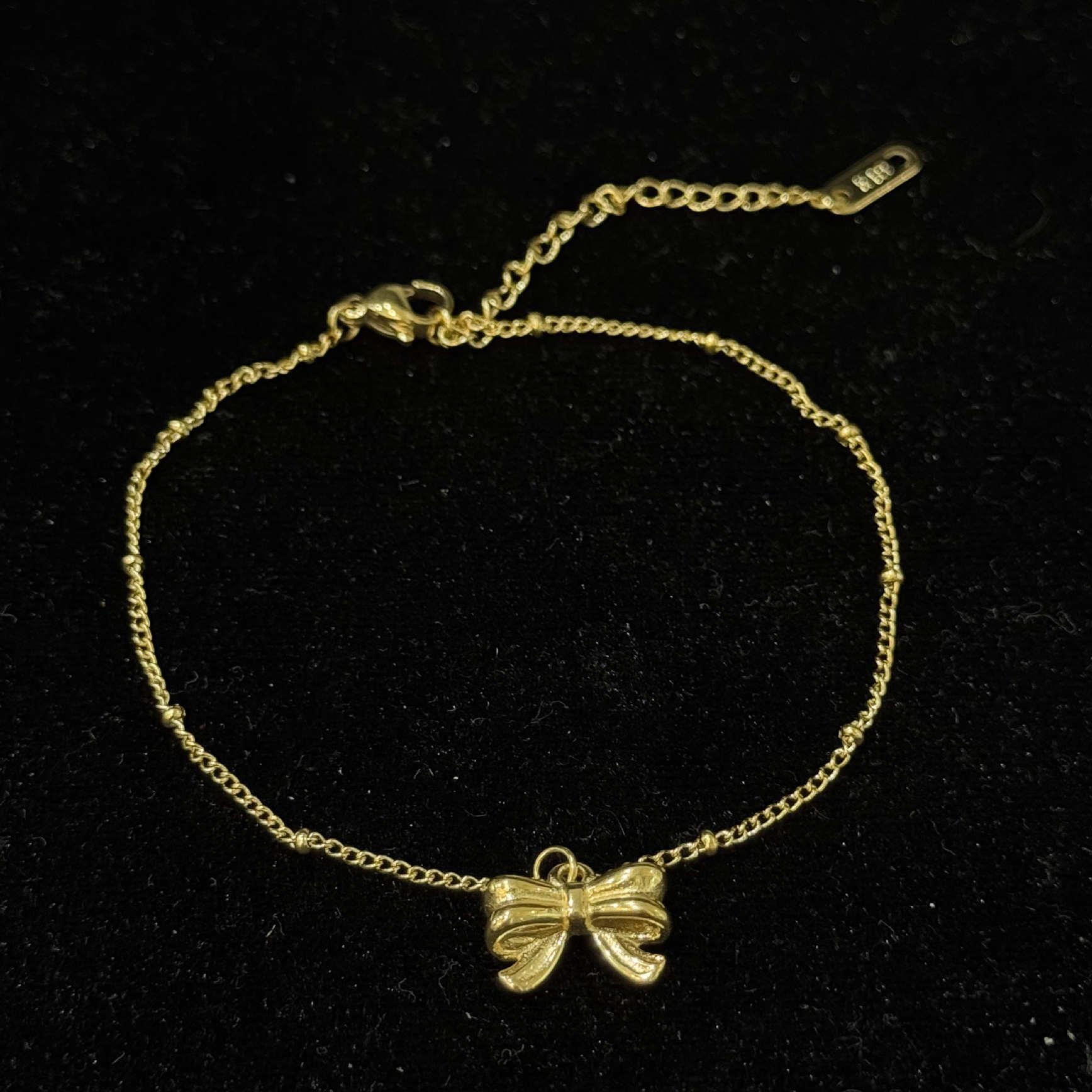 lắc chân titan sợi vàng mảnh chiếc nơ dập nổi 