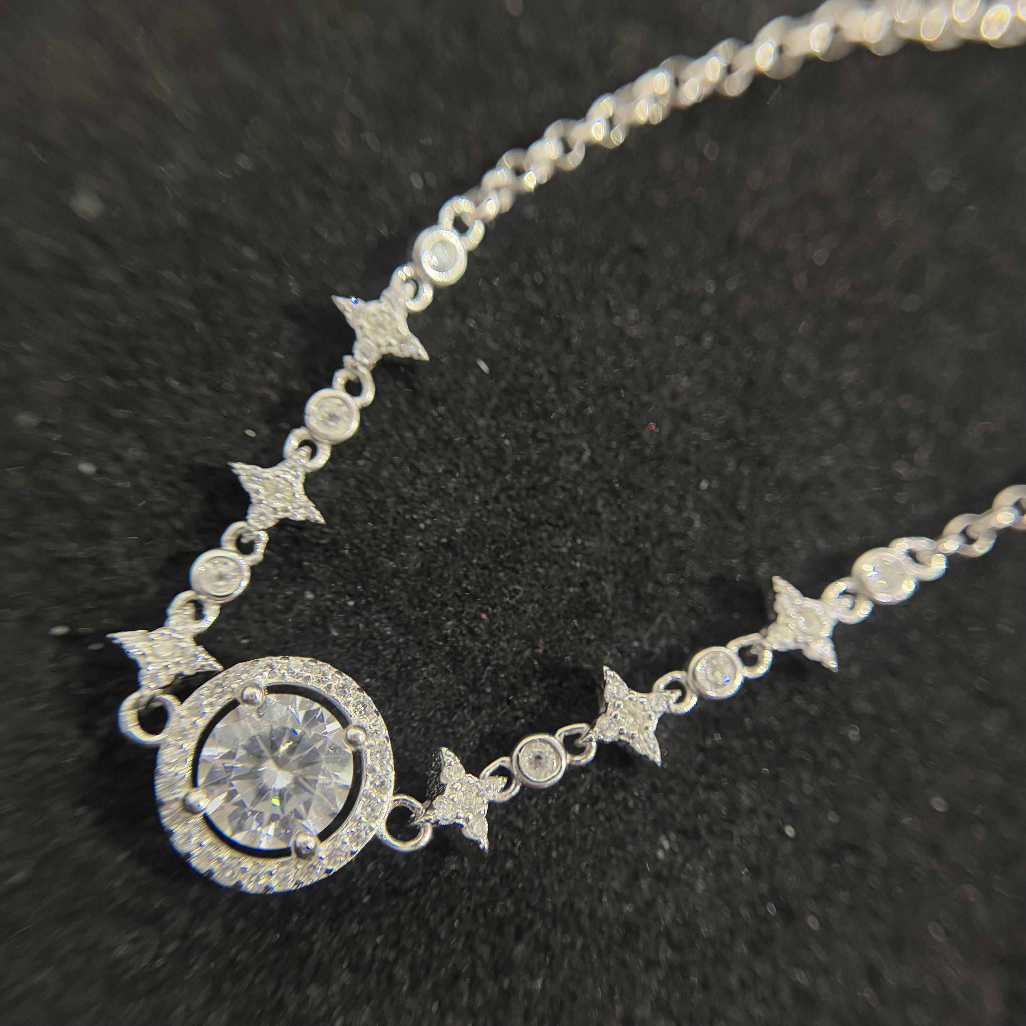 vòng tay bạc xi bạch kim kim cương trắng trụ tròn đính ngôi sao bốn cánh dây rút