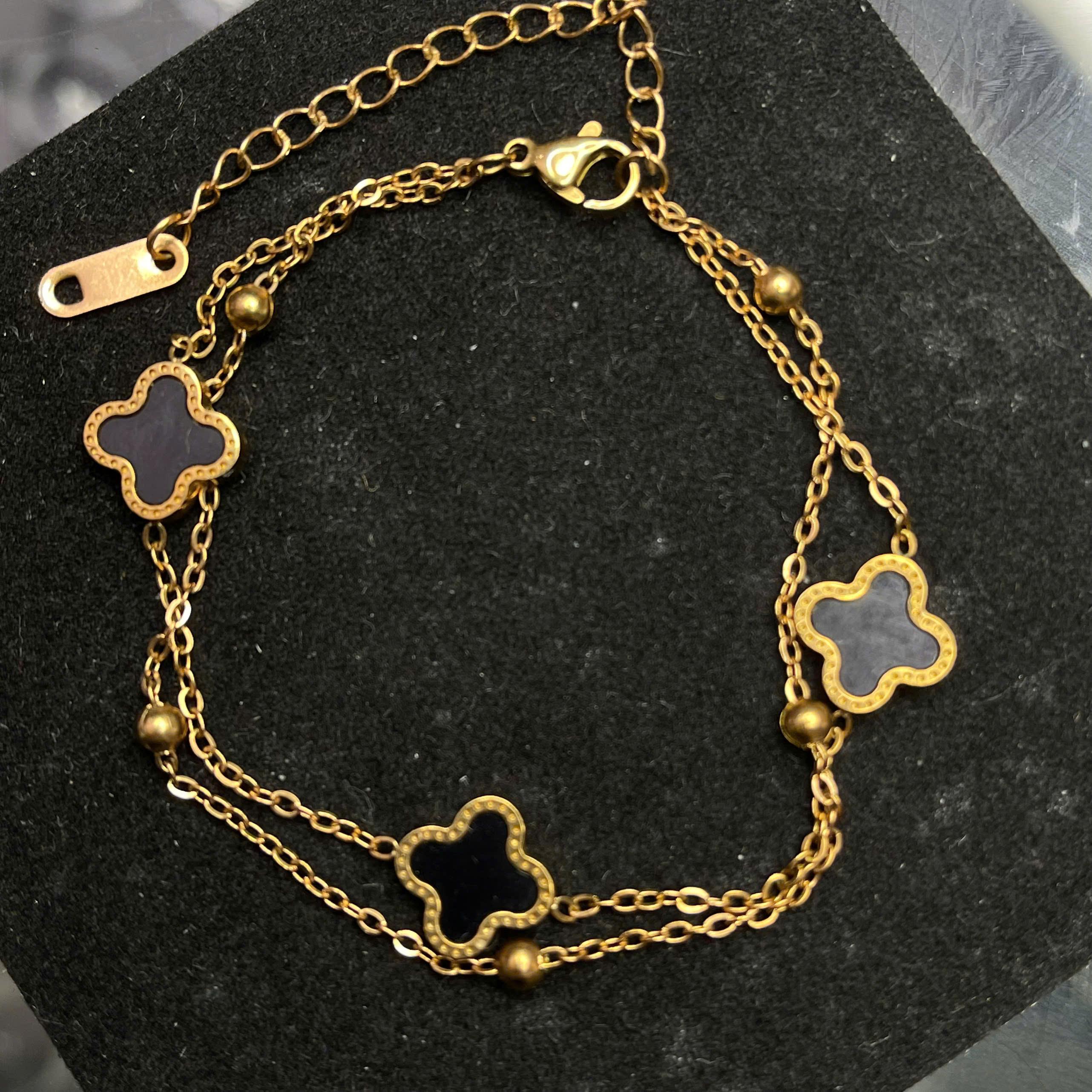 vòng tay titan màu vàng charm năm hoa đen.