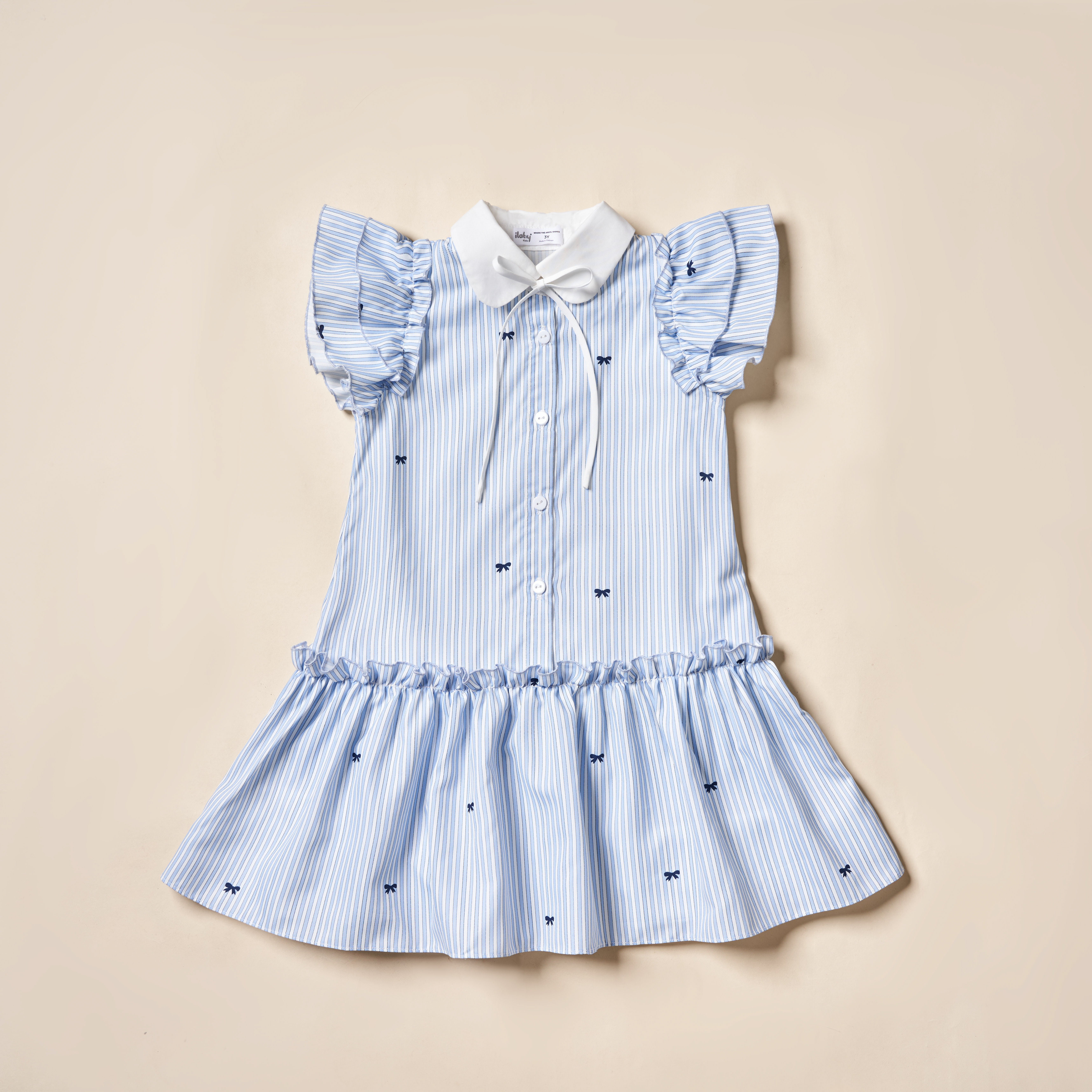 Váy kẻ in nơ tay cánh tiên