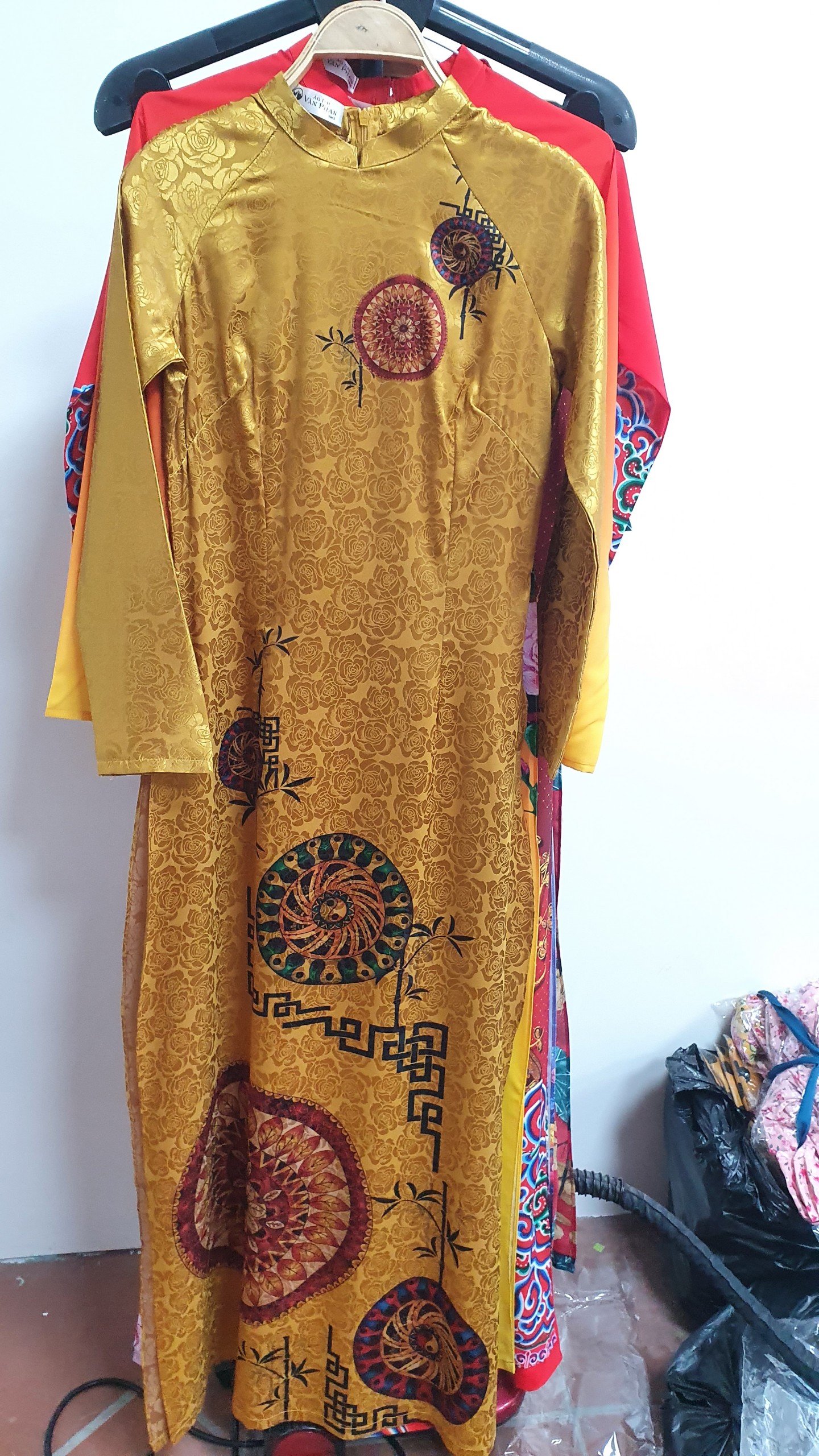 A2016 áo dài gấm vân hoa hồng cổ 2p tay dài nền vàng đồng thổ cẩm chữ chiện